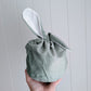 Sage velvet drawstring bag with floppy bunny ear.