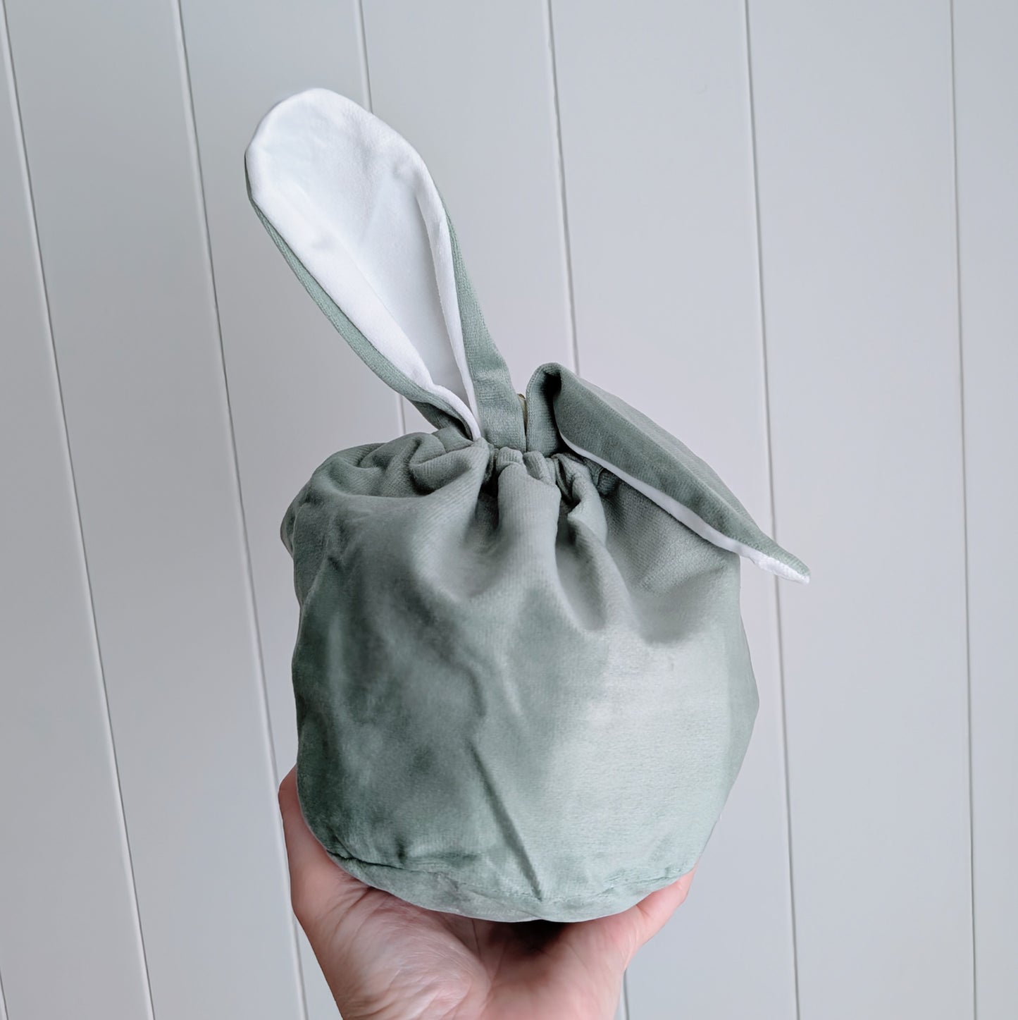 Sage velvet drawstring bag with floppy bunny ear.
