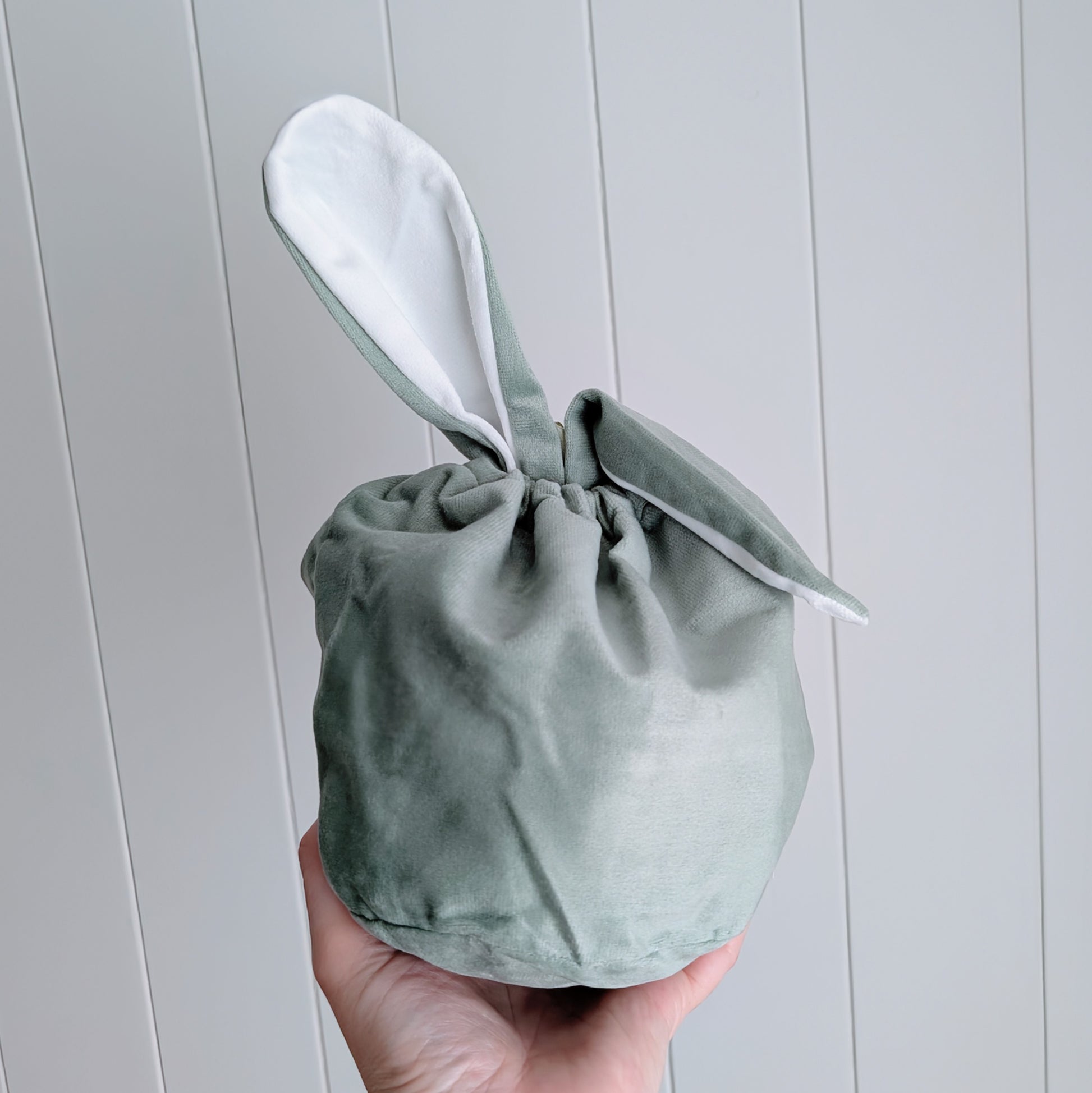 Sage velvet drawstring bag with floppy bunny ear.