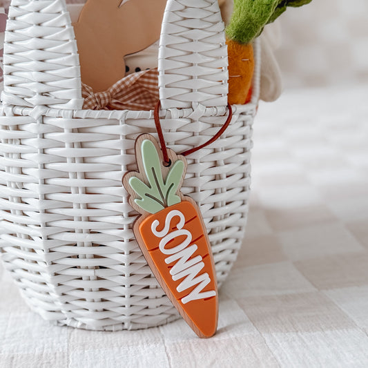 Carrot-shaped toy with 'SONNY' on it in front of a white basket.